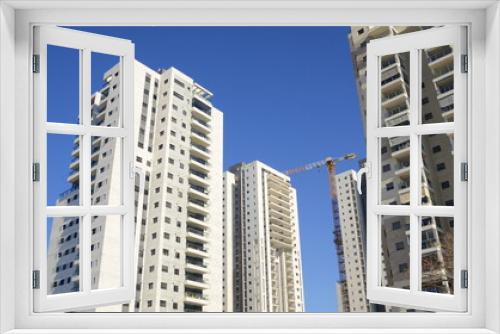 Fototapeta Naklejka Na Ścianę Okno 3D - Beautiful white residential buildings. Modern area, new buildings. Real estate in Israel. Tenement house Tall new residential buildings against the sky, space for text