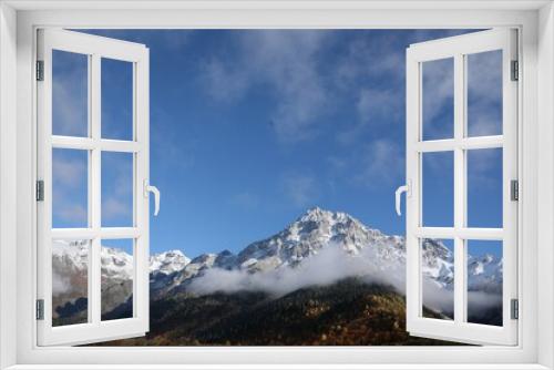 Fototapeta Naklejka Na Ścianę Okno 3D - Picturesque landscape of high mountains covered with thick mist under blue sky on autumn day