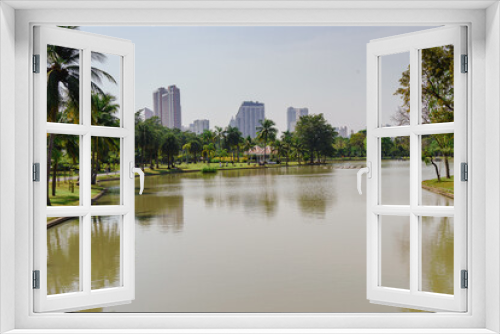 Fototapeta Naklejka Na Ścianę Okno 3D - Landscape of park with lake, trees and building in Bangkok, Thailand