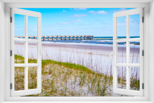 Fototapeta Naklejka Na Ścianę Okno 3D - Seascape over the grassy sand dune and seagulls near JAX Fishing Pier in Jacksonville, North Florida