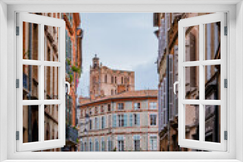 Fototapeta Naklejka Na Ścianę Okno 3D - Beautiful facades with bricks in Perchepinte street and the Saint Etienne cathedral bell tower in Toulouse old town, in the south of France (Haute Garonne)