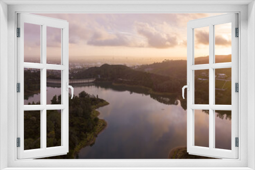 Fototapeta Naklejka Na Ścianę Okno 3D - High-angle views taken from a drone of Lake Hollywood, or Hollywood Reservoir, in the Hollywood neighborhood of Los Angeles, California. Pictures taken after a large rainfall showing the lush foliage.