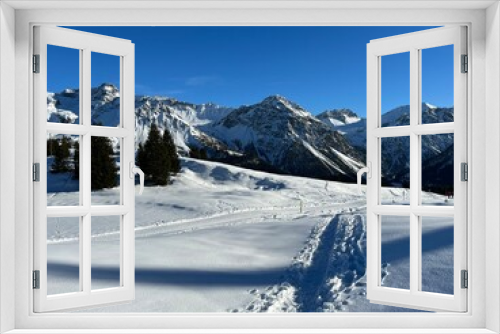 Fototapeta Naklejka Na Ścianę Okno 3D - Wonderful winter hiking trails and traces in the fresh alpine snow cover of the Swiss Alps and over the tourist resort of Arosa - Canton of Grisons, Switzerland (Schweiz)