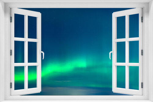 Fototapeta Naklejka Na Ścianę Okno 3D - Green Aurora borealis or polar lights on night blue sky