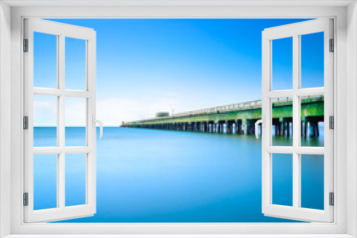Fototapeta Naklejka Na Ścianę Okno 3D - Industrial pier on the sea. Side view. Long exposure photo