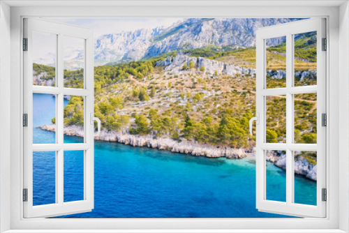 Fototapeta Naklejka Na Ścianę Okno 3D - Take in the breathtaking aerial view of Makarska Riviera in Croatia, revealing a picturesque rocky beach and the vibrant turquoise water.