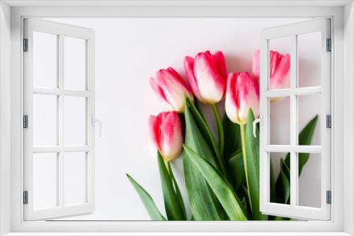 Fototapeta Naklejka Na Ścianę Okno 3D - Pink tulip flowers bouquet on white background. Flat lay, top view. Selective focus. Shallow depth of field