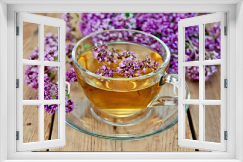 Fototapeta Naklejka Na Ścianę Okno 3D - Herbal tea from oregano in a glass cup on a board