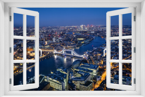 Fototapeta Naklejka Na Ścianę Okno 3D - Elevated view of the illuminated skyline of London with Tower Bridge and Thames River during night time, England