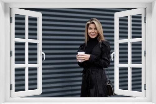 businesswoman resting on the street and drinking coffee