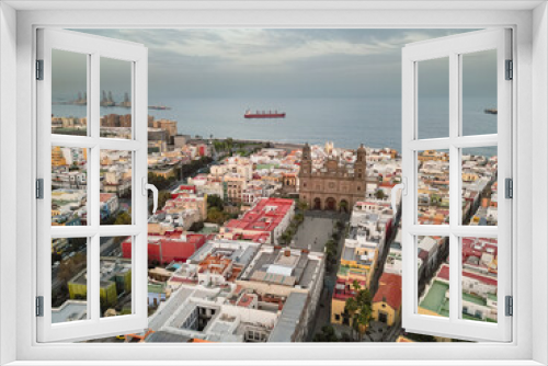 Fototapeta Naklejka Na Ścianę Okno 3D - Aerial view of cathedral, square and rooftops in old town with view of the ocean and a ship in the background in the city of Las Palmas de Gran Canaria, Spain