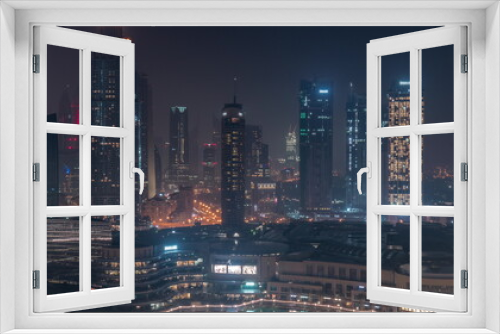 Fototapeta Naklejka Na Ścianę Okno 3D - Aerial view of Dubai International Financial Centre DIFC district all night timelapse