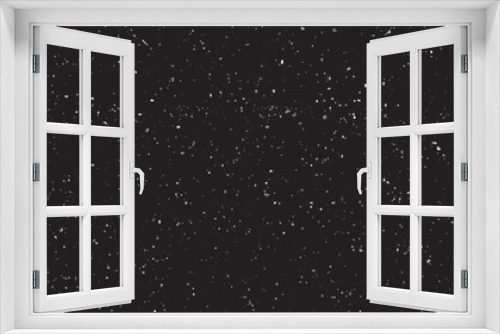 Snowfall on a black background. Flying dust particles on a black background
