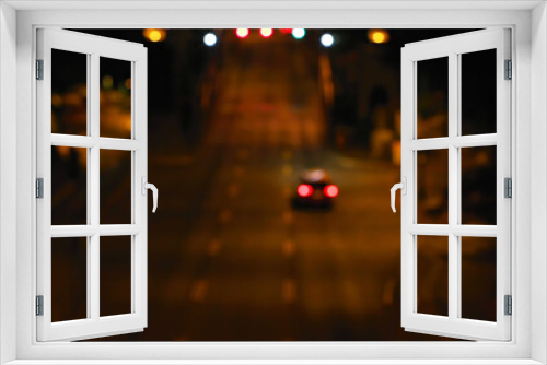 Fototapeta Naklejka Na Ścianę Okno 3D - Blurred city street with car and light spots