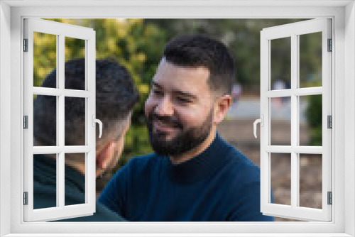 gay couple in the park, cuddling, loving and playful