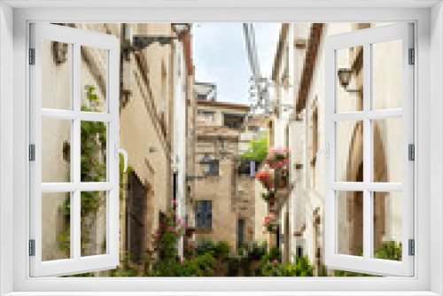 Fototapeta Naklejka Na Ścianę Okno 3D - The narrow alleys of Tossa de Mar, Spain, lead to hidden courtyards and picturesque squares..