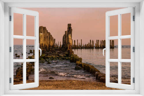 Fototapeta Naklejka Na Ścianę Okno 3D - Old ruined wooden pier and a sandy beach