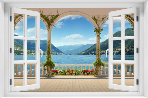 Fototapeta Naklejka Na Ścianę Okno 3D - Beautiful view from the terrace over Lake Como and the mountains. Terrace with columns and balustrade of a Mediterranean palazzo on a sunny day.