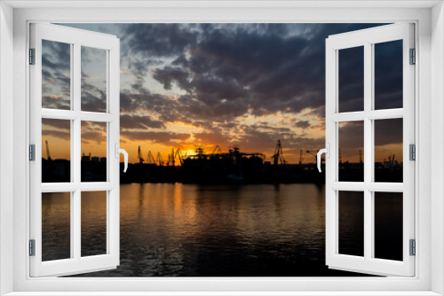 Fototapeta Naklejka Na Ścianę Okno 3D - sunset in industrial landscape of commercial seaport. Sunset at seaport.