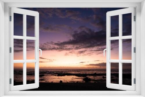 Fototapeta Naklejka Na Ścianę Okno 3D - Scenic view of a beautiful sunset visible on the horizon of a beach