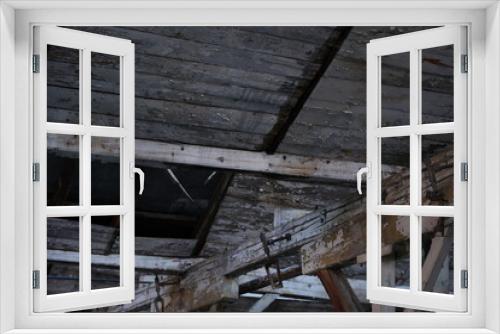 Fototapeta Naklejka Na Ścianę Okno 3D - Dilapidated old wooden beams on the ceiling of the house, brown and gray shades