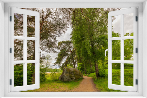 Fototapeta Naklejka Na Ścianę Okno 3D - Beautiful view of summer landscape with lake view and large stone in forest on side of hiking trail. Sweden.