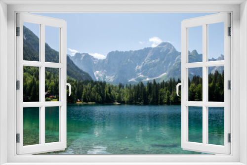 Fototapeta Naklejka Na Ścianę Okno 3D - View of Lago Inferiore die Fusine in the Julian Alps of northeastern Italy with the dramatic rock face of Mount Mangart in the background