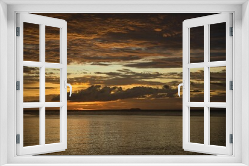 Fototapeta Naklejka Na Ścianę Okno 3D - Picturesque sunset on the beach of Siquijor in the Philippines, the whole sky glows in golden yellow color.