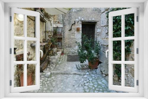 Fototapeta Naklejka Na Ścianę Okno 3D - A narrow street among the old houses of Fumone, a historic town in the state of Lazio in Italy.