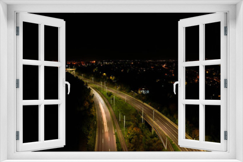 Fototapeta Naklejka Na Ścianę Okno 3D - Top down view to road. Romantic night aerial photo of cars traveling. The light on the road at night in city. Background scenic road drone view. Tram railways background