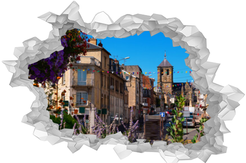 Scenic street view of blooming small French town of Rethel decorated with garlands of multicolored mini flags overlooking medieval Saint-Nicolas Church