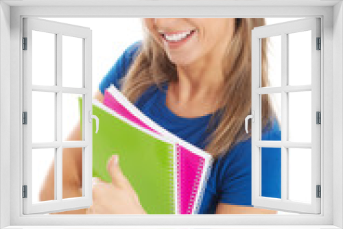 Young happy and satisfied student holding workbook.