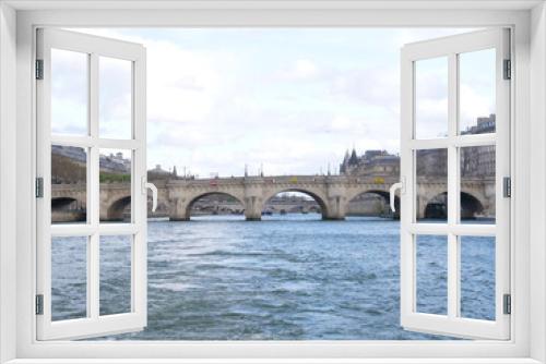 Fototapeta Naklejka Na Ścianę Okno 3D - A view from a boat of the Seine river on a cloudy day. 