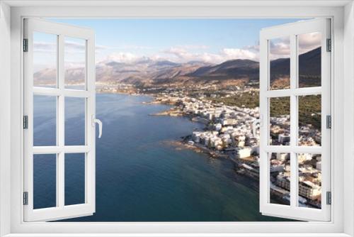 Fototapeta Naklejka Na Ścianę Okno 3D - Aerial view of the city of Chersonissos along the coastline of the Aegean sea in Crete.