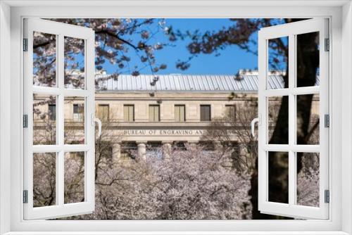 Fototapeta Naklejka Na Ścianę Okno 3D - The Bureau of Engraving and Printing Seen Through Cherry Blossom Trees in Washington D.C.