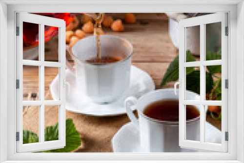 Fototapeta Naklejka Na Ścianę Okno 3D - Cup of tasty raspberry tea on wooden table. Useful drink for health. Herbal tea. Traditional medicine.