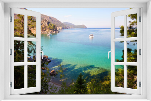 Fototapeta Naklejka Na Ścianę Okno 3D - Picturesque summer landscape of Lake Baikal. Yachts in Babushka Bay, turquoise water color. Coniferous forest. Recreation and travel in the wild.