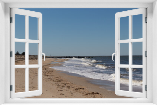 Fototapeta Naklejka Na Ścianę Okno 3D - I loved the look of this beach as the waves battered the shore. The whitecaps of the waves make it look rough. The beautiful blue sky with no clouds in site make this look like a beautiful summer day.