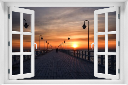 Fototapeta Naklejka Na Ścianę Okno 3D - Beautiful sunrise over the Polish sea. Popular pier on the Baltic Sea at sunrise. Photo taken in Gdynia, Poland.