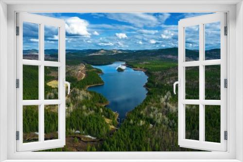 Fototapeta Naklejka Na Ścianę Okno 3D - Lake in a green field under blue cloudy sky in Quebec, Canada