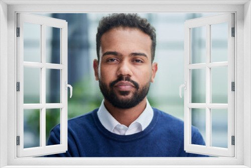 Smiling millennial confident black guy posing for photo, looking at camera