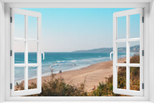 Fototapeta Naklejka Na Ścianę Okno 3D - Amazing wide panoramic view of the ocean with hypnotic waves rolling onto the pristine sandy beach during stunning sunrise. 