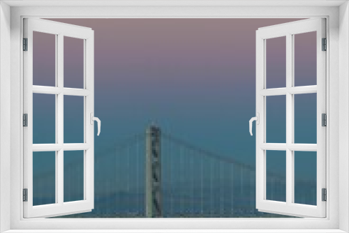 Fototapeta Naklejka Na Ścianę Okno 3D - The Oakland Bay Bridge on the water under a pink and blue sky in San Francisco, California