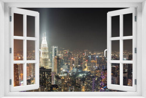 Fototapeta Naklejka Na Ścianę Okno 3D - Night time view of Kuala Lumpur City skyscrapers with patronas towers lights