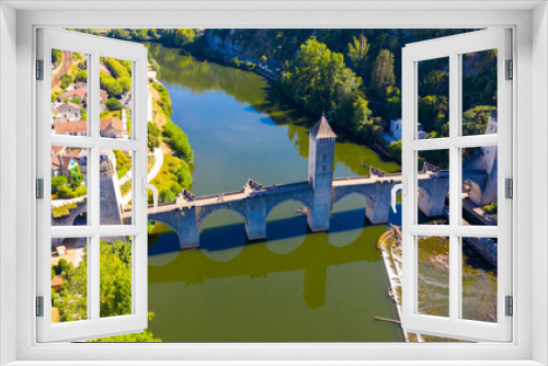 Fototapeta Naklejka Na Ścianę Okno 3D - View from drone of medieval fortified arched Pont du Diable or Valentre bridge on river Lot in French town of Cahors in summer