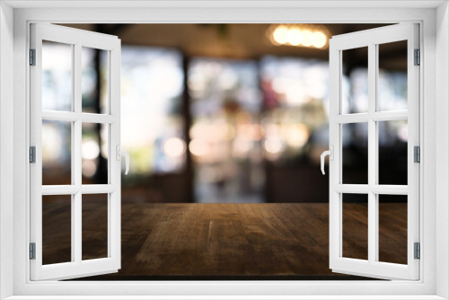 Empty dark wooden table in front of abstract blurred bokeh background of restaurant . can be used for display or montage your products.Mock up for space.