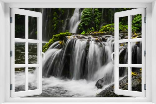 Fototapeta Naklejka Na Ścianę Okno 3D - Beautiful Banyu Wana Amertha Waterfall which is located in Wanagiri, Sukasada, Buleleng, Bali, Indonesia. A natural tall waterfall with lots of plants on the rocks with a natural pool at the bottom.