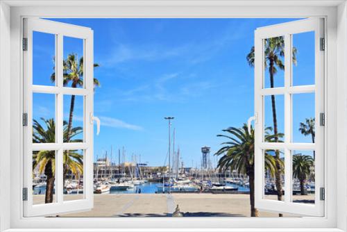Fototapeta Naklejka Na Ścianę Okno 3D - view of the city port with yachts, palm trees, blue sky, sunny day. Barcelona, Spain 