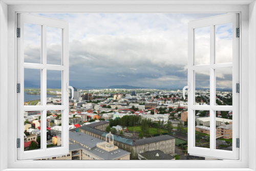 Fototapeta Naklejka Na Ścianę Okno 3D - Aerial view of colorful buildings and lush greenery of Reykjavik, Iceland