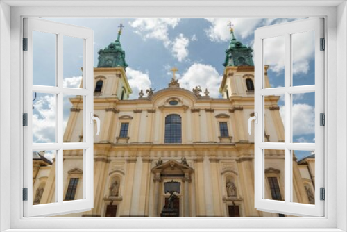 Low angle of the Holy Cross Church in baroque architectural style in Warsaw, Poland
